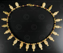 Bone skittles and garnet necklace 623. Designed by François Villaret.