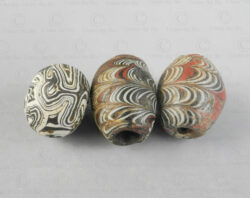 Three ancient folded glass beads 22SH7. Found in Afghanistan. Islamic period, circa 9th-12th century.